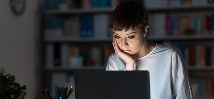 woman doing research on laptop computer