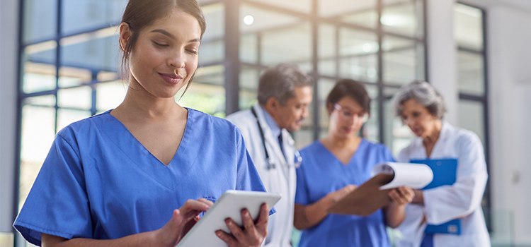 nurse looking at information on tablet