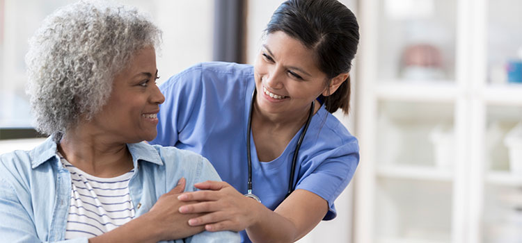 nurse shares a laugh with adult patient