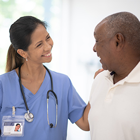 female nurse talking with older patient