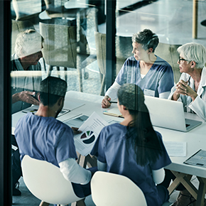 team of nurses on laptops in work session