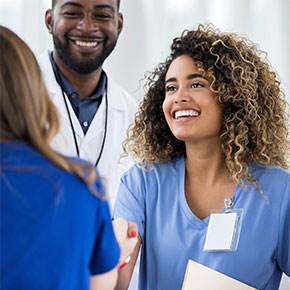 woman nurse shaking hands with other staff