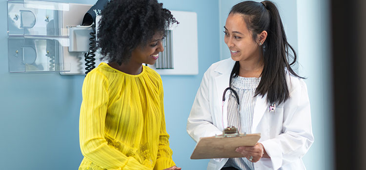 woman nurse taking patient vitals