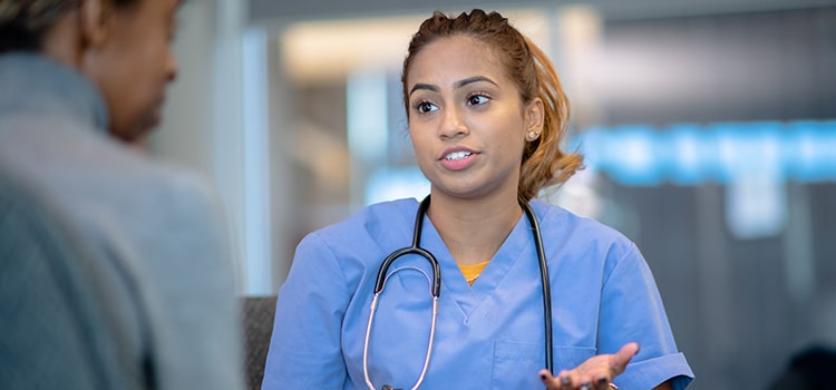 advanced practice nurse talks with patient privately