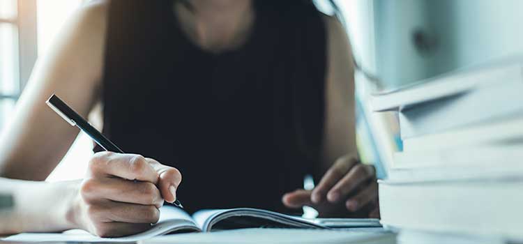 cropped photo of student studying and holding pencil