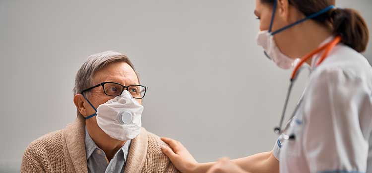 man comforting older man in chair prior to procedure