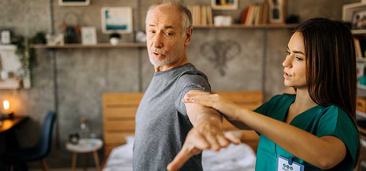 nursing helping patient with stretching exercise