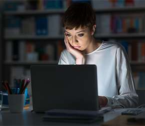 woman doing research on laptop computer
