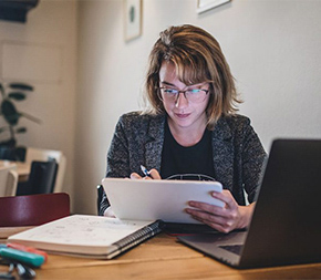 woman working on electronic notepad