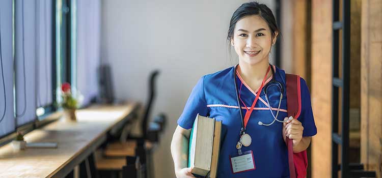smiling nurse with books and satchel