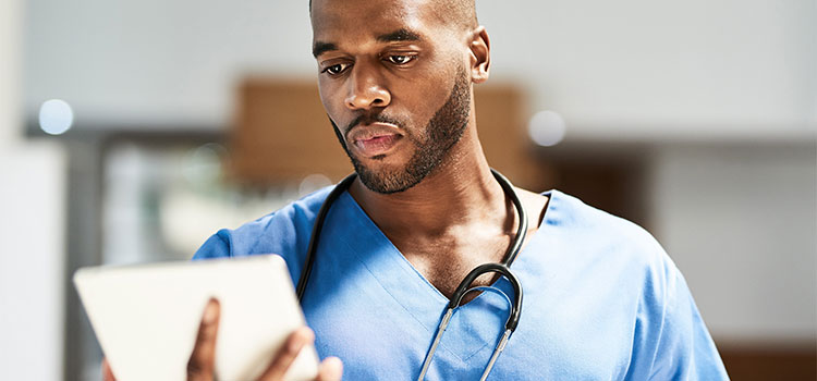 nurse looking at electronic notepad
