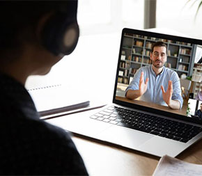 student in online video class with instructor and other students