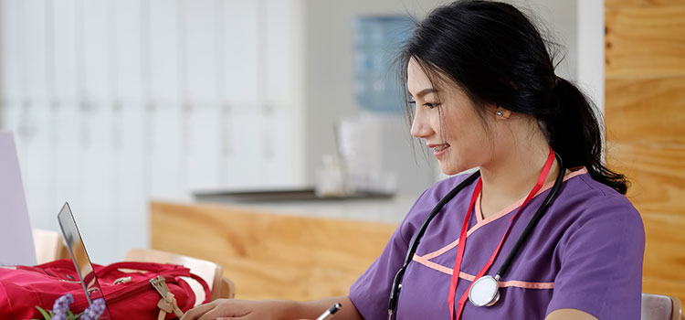 nurse studying coursework to keep up license