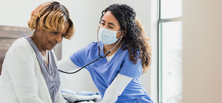 cardiovascular nurse checking on patient