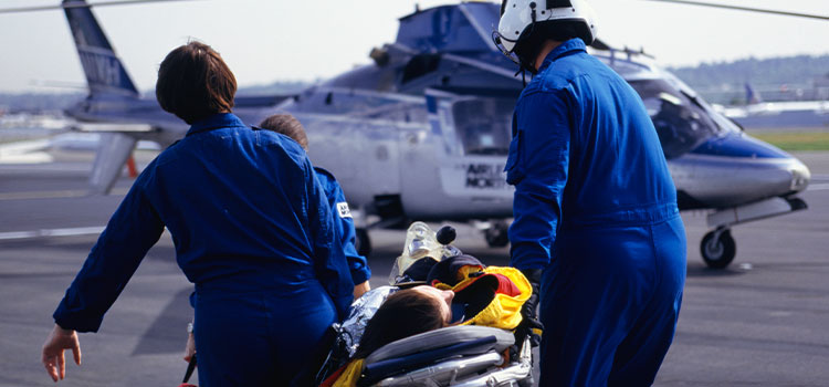 flight nurses transporting patient to helicopter