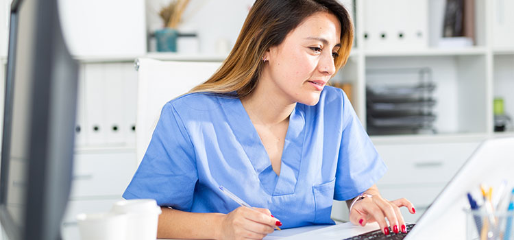 nurse studying at laptop computer