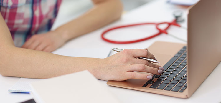 nurse student taking test on laptop computer