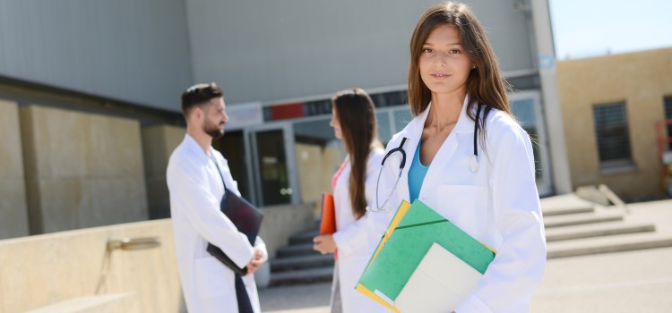 nurse posing outside of school