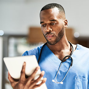 male nurse looking at electronic notepad