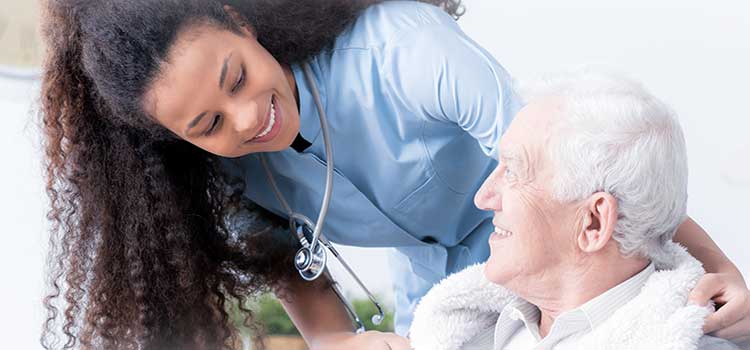 female nurse works with elderly patient