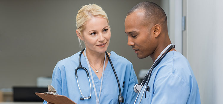 two nurses conferring over chart