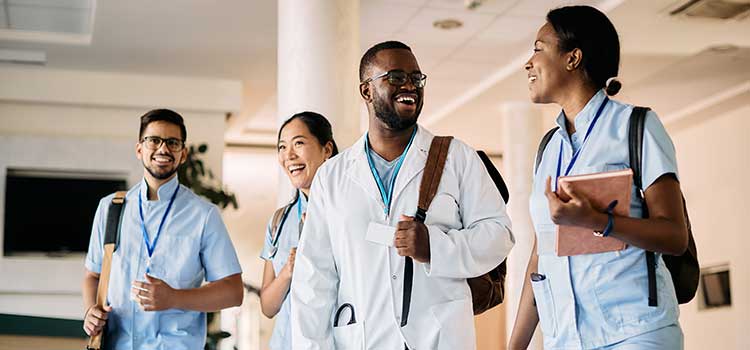 group of diverse nurse students walking together