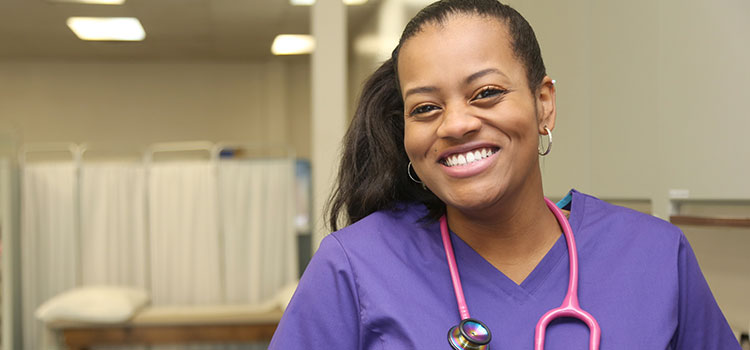 smiling nurse in exam room