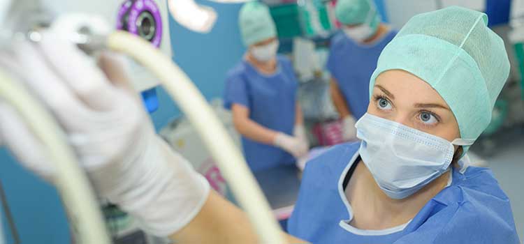 or nurse attaches tube to vitals machine before surgery