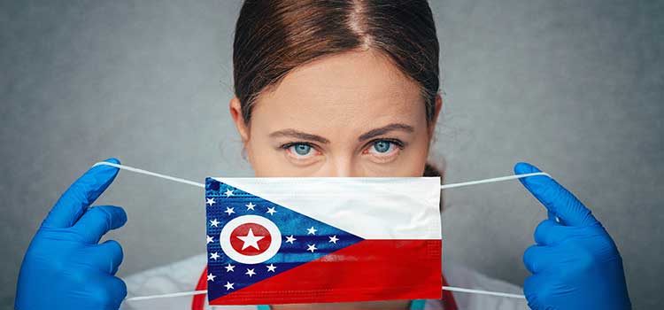 nurse putting on ohio flag mask