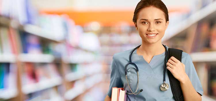 nurse student carries books in library