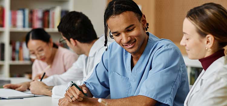 teacher works with male nursing student before taking exam