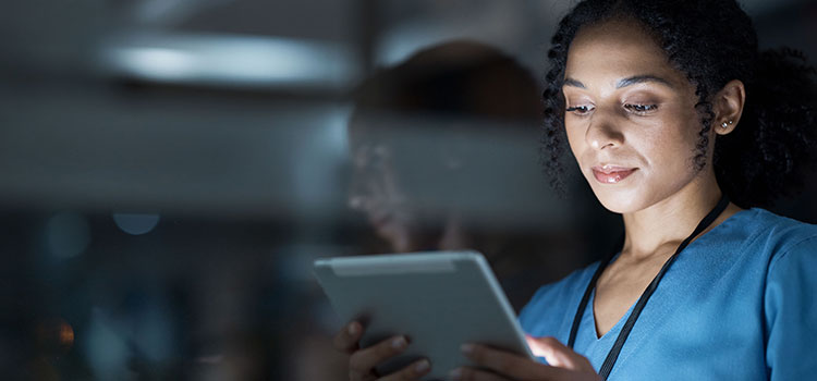 nurse reviews information on tablet