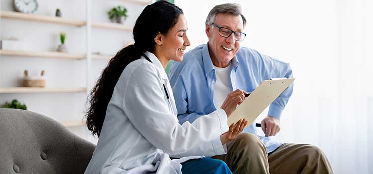 nurse reviews insurance forms with patient prior to procedure