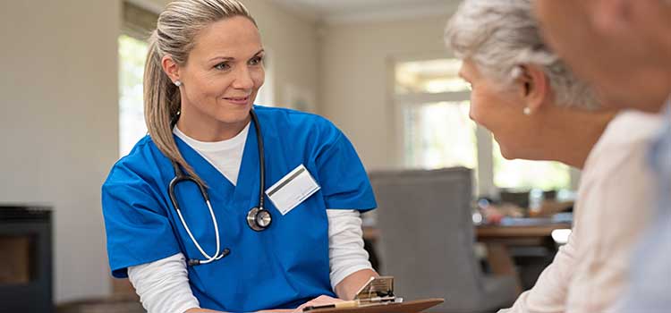 nurse takes vitals of senior couple