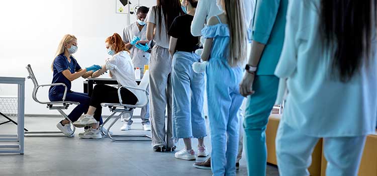 research nurse gives injections to clinical trials volunteers