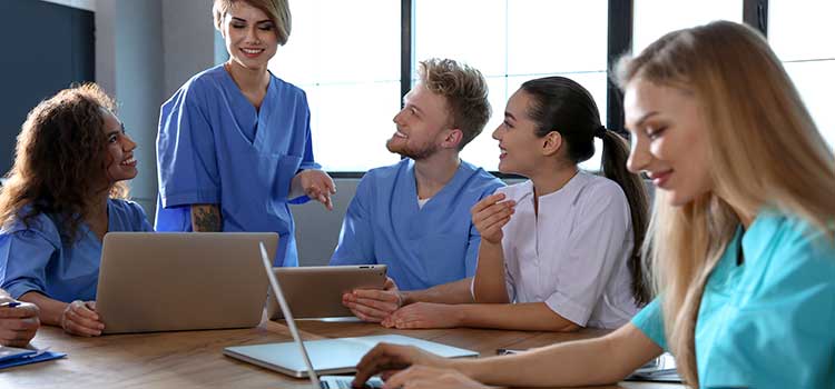 nurse studying for certification with other nurses