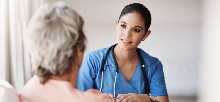 a nurse takes vital signs on an elderly patient